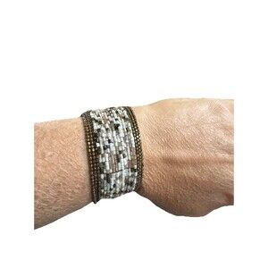 Vintage 90s" or handmade boho-style beaded cuff bracelets.